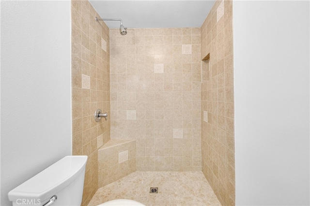 full bathroom with toilet and a tile shower