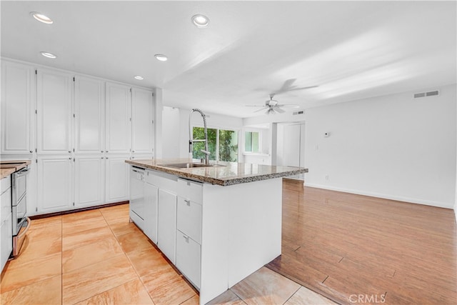 kitchen with stone countertops, visible vents, ceiling fan, white dishwasher, and white cabinetry