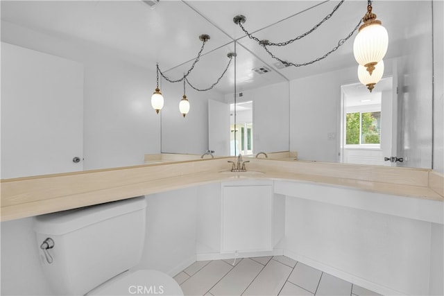 bathroom with toilet, tile patterned flooring, visible vents, and vanity