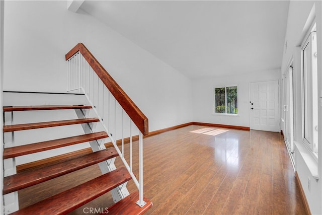 interior space with wood-type flooring and baseboards