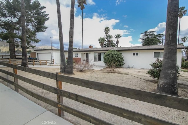 ranch-style house with fence