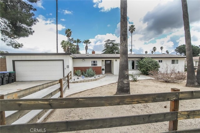 single story home with a garage and driveway