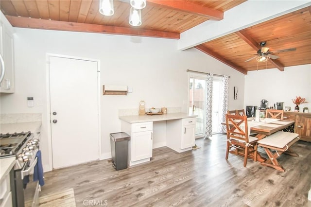 dining area featuring a ceiling fan, wooden ceiling, vaulted ceiling with beams, and light wood-style flooring