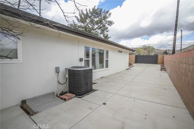 view of patio / terrace with central AC and a fenced backyard