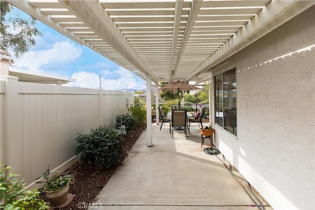 view of patio / terrace with outdoor dining area, a fenced backyard, and a pergola