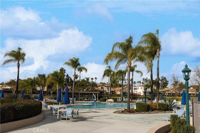 exterior space with a patio, a swimming pool, and fence