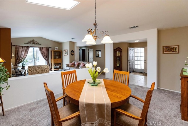 carpeted dining room with visible vents, vaulted ceiling, a chandelier, tile patterned flooring, and baseboards