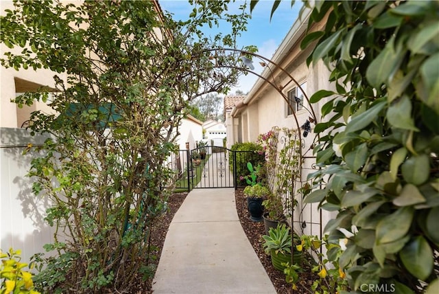 view of property's community with fence and a gate