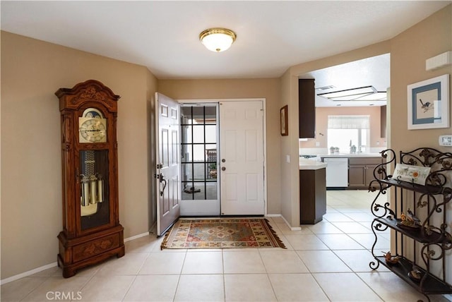 entrance foyer with light tile patterned floors and baseboards