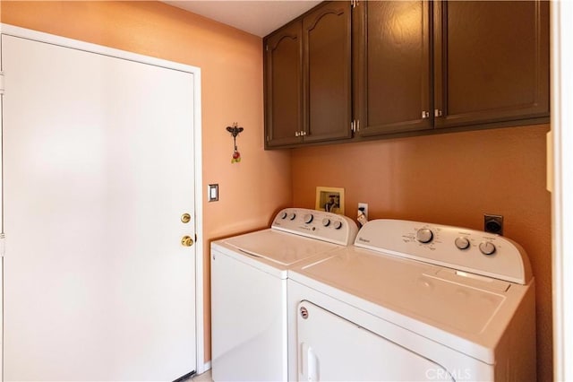 clothes washing area with cabinet space and washer and dryer