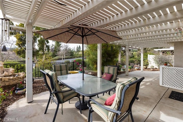 view of patio featuring outdoor dining area and fence