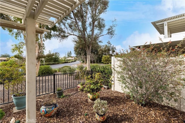 view of yard with fence and a pergola