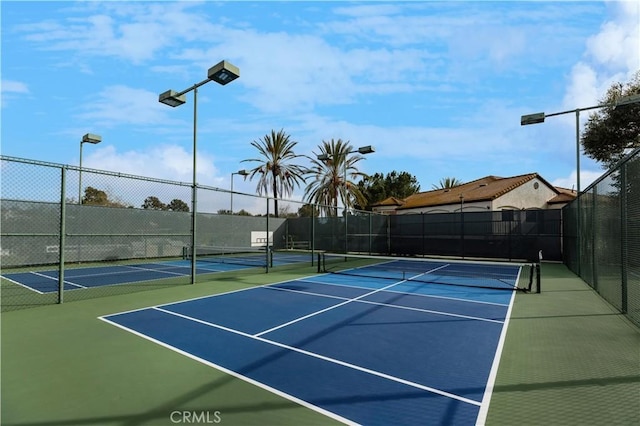 view of sport court featuring fence