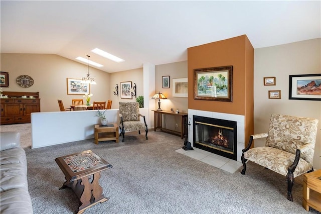 living room with carpet floors, a tiled fireplace, and lofted ceiling