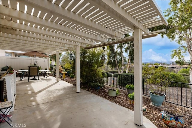 view of patio featuring outdoor dining space, a fenced backyard, and a pergola