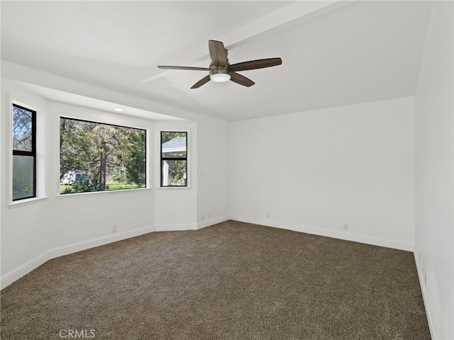 empty room with lofted ceiling, baseboards, dark carpet, and ceiling fan