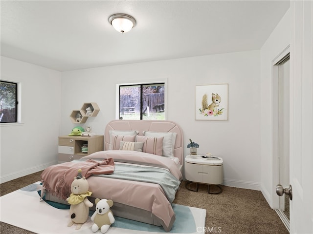 bedroom featuring carpet flooring and baseboards