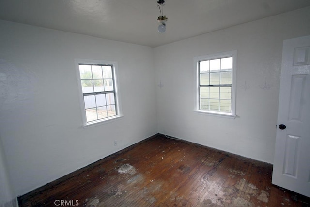 unfurnished room featuring dark wood-style floors