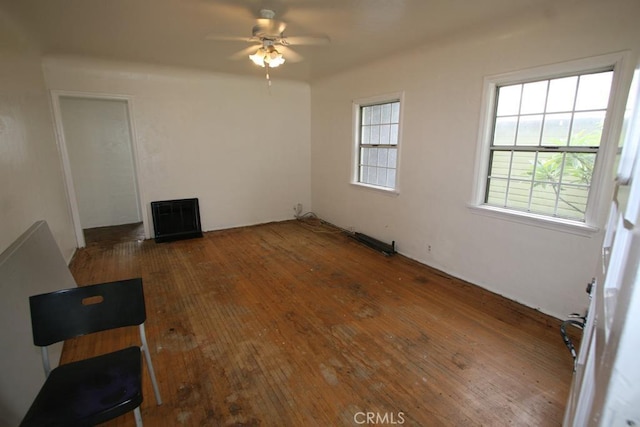 living area with plenty of natural light, hardwood / wood-style floors, and ceiling fan