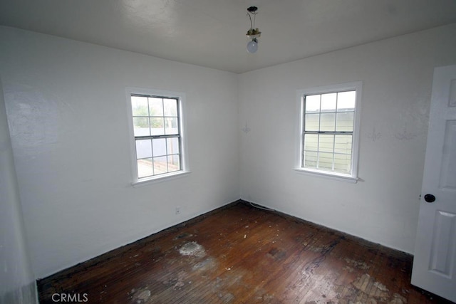 unfurnished room with dark wood-style flooring