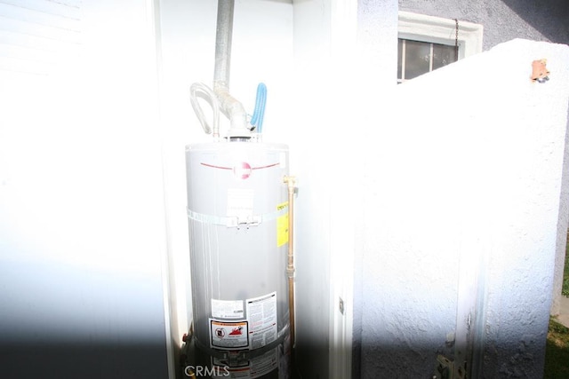 utility room featuring secured water heater