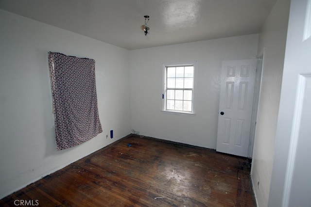 empty room with hardwood / wood-style flooring