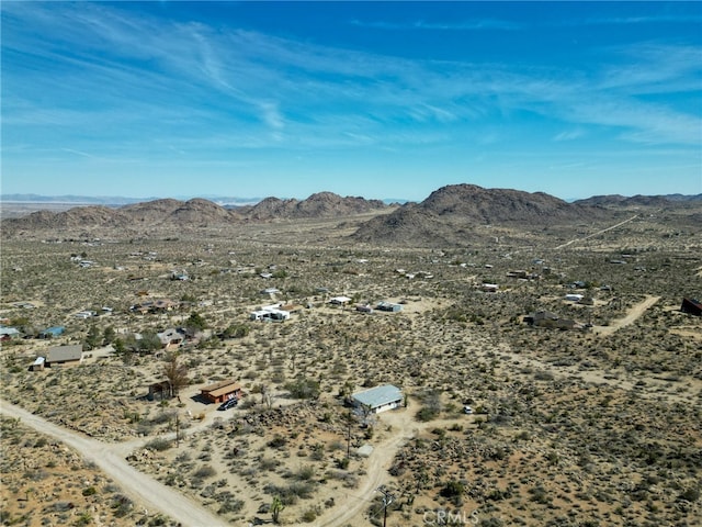 aerial view featuring a mountain view and a desert view