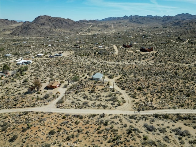 birds eye view of property with a mountain view and view of desert