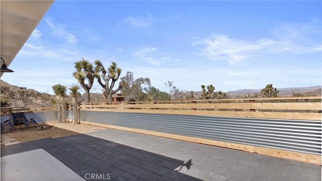 view of patio featuring fence