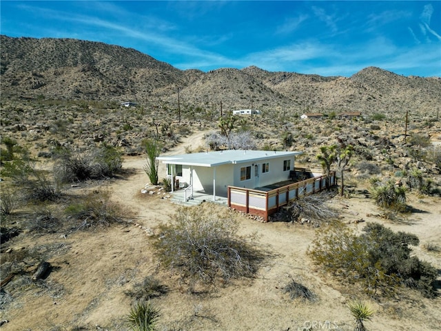 exterior space with a mountain view, a rural view, and view of desert