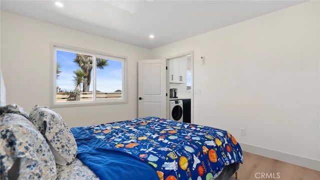 bedroom with washer / dryer, recessed lighting, baseboards, and light wood finished floors