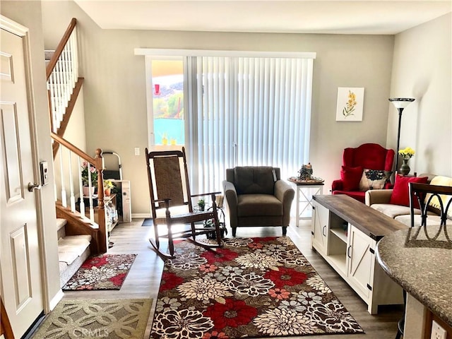 living area featuring dark wood-type flooring and stairway