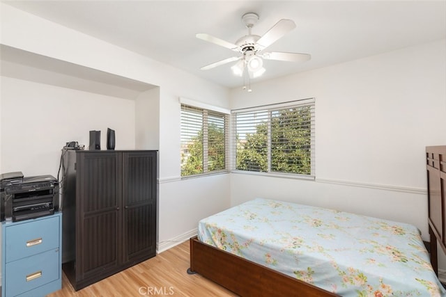 bedroom featuring light wood-style flooring and ceiling fan