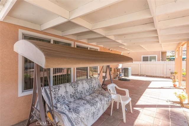 view of patio with central AC unit and fence