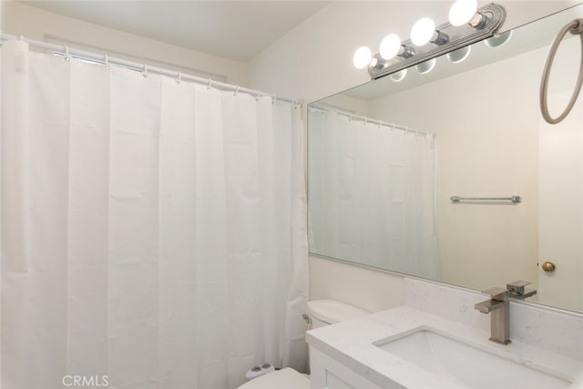 bathroom featuring toilet and vanity