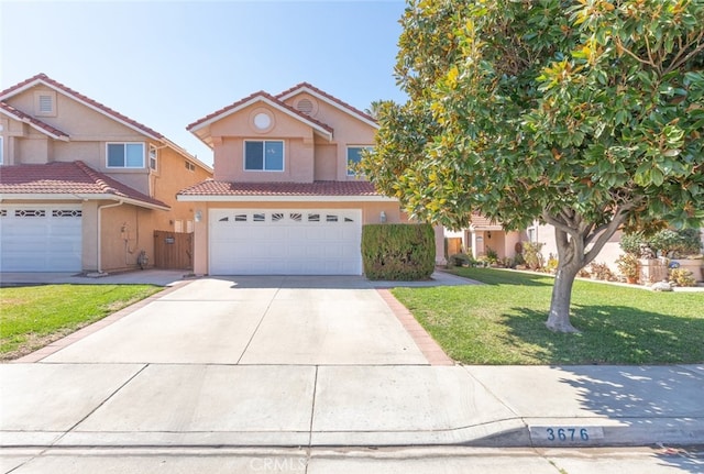 traditional-style home with an attached garage, a tiled roof, driveway, stucco siding, and a front lawn