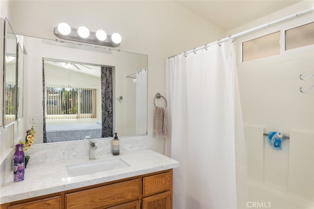 full bath featuring lofted ceiling, curtained shower, and vanity