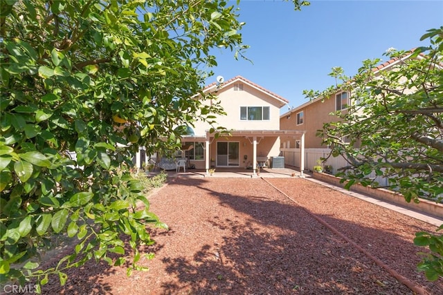 back of house with central air condition unit, stucco siding, a patio area, a pergola, and a fenced backyard