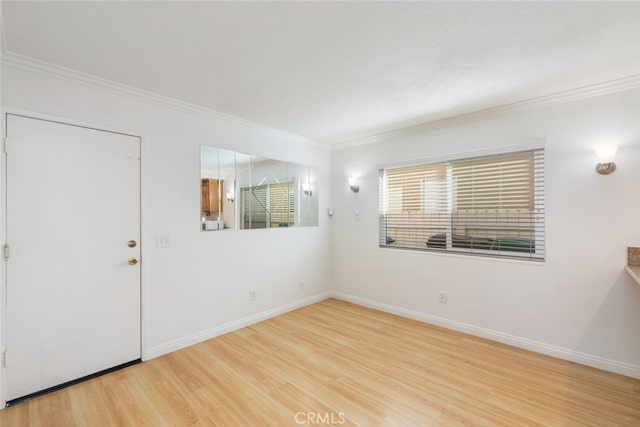 unfurnished room featuring baseboards, ornamental molding, and wood finished floors