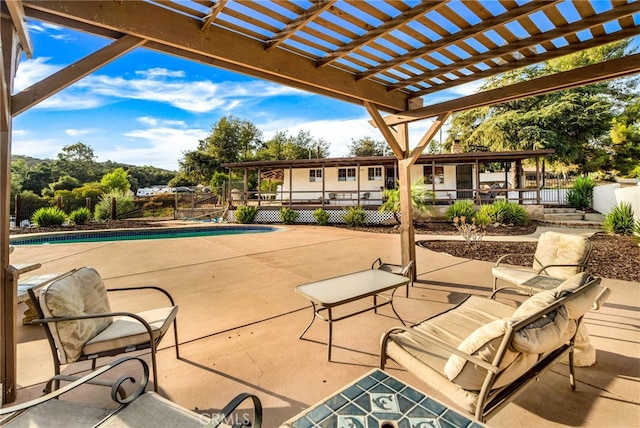 view of patio featuring fence, a fenced in pool, and a pergola