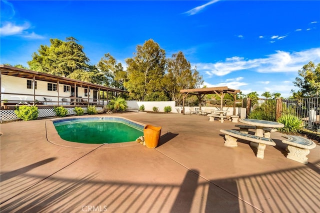 view of swimming pool with a patio area, fence, and a fenced in pool