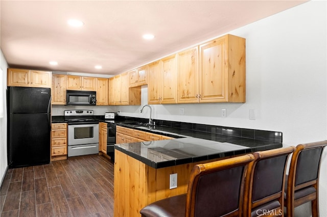 kitchen featuring dark wood-type flooring, light brown cabinets, a sink, and black appliances