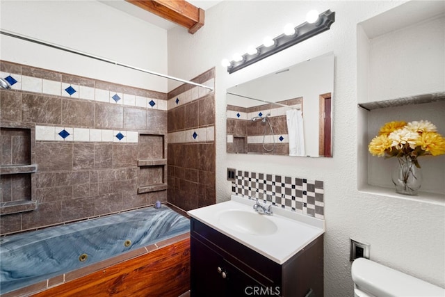 full bath featuring toilet, a combined bath / shower with jetted tub, beam ceiling, and vanity