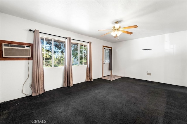 unfurnished room featuring ceiling fan, dark colored carpet, and a wall unit AC