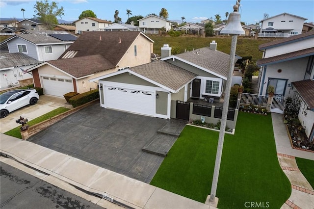 view of front facade with an attached garage, a shingled roof, fence, driveway, and a residential view