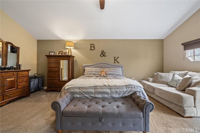 bedroom with vaulted ceiling, a ceiling fan, and light colored carpet