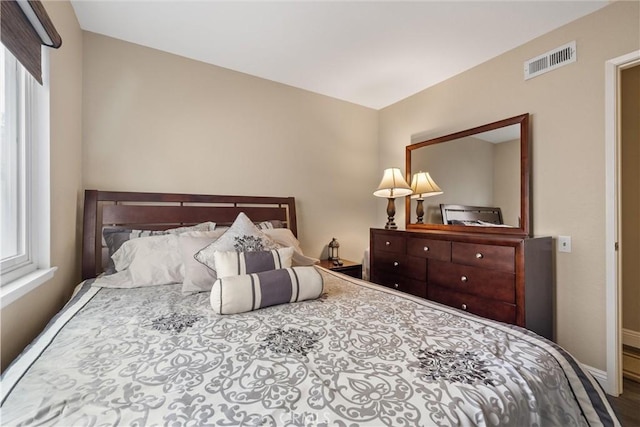 bedroom featuring visible vents and baseboards