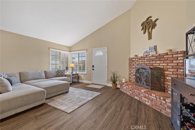 living area featuring baseboards, a fireplace, high vaulted ceiling, and wood finished floors