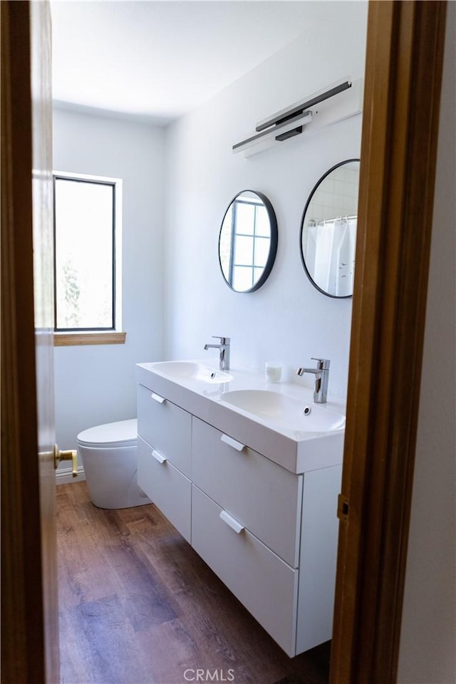 1075 Rivera Dr, Wrightwood, CA 92397 - full bathroom featuring a sink, double vanity, wood finished floors, and toilet