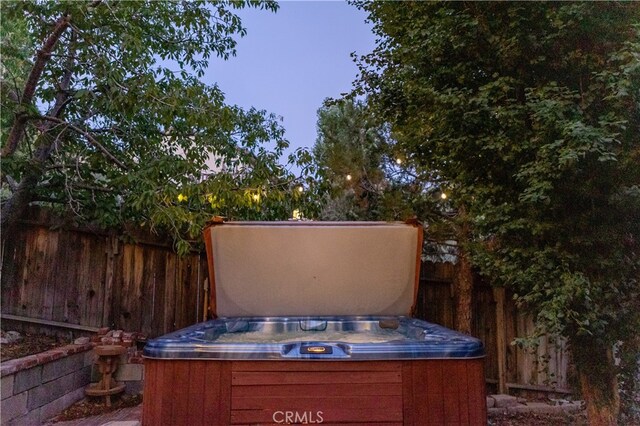 1075 Rivera Dr, Wrightwood, CA 92397 - view of patio / terrace featuring a hot tub and fence